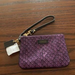 Purple with black wristlet. Made by coach